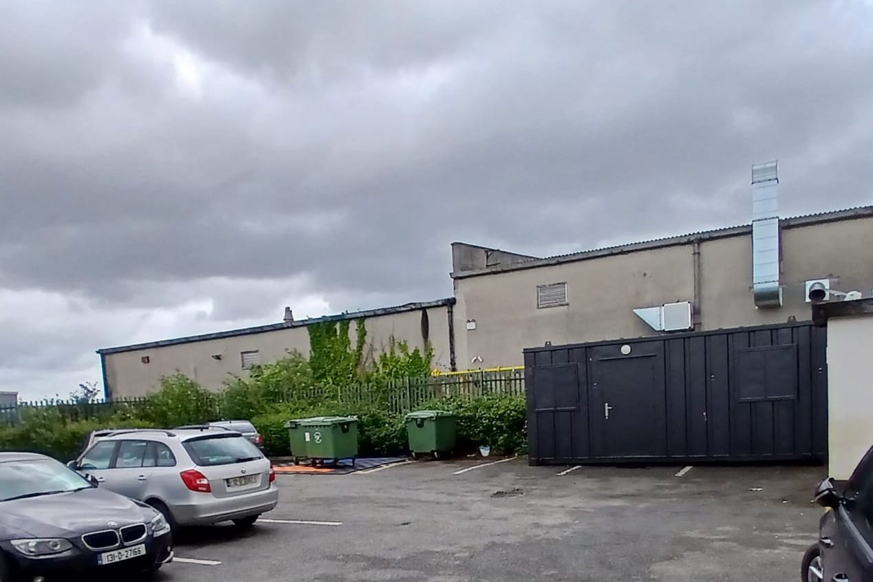A drone launch pad with wheelie bins on it, and a container office, in the car park at Manna's location in Glasnevin. 