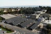 Solar panels over cars in a surface car park.