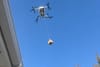 Still from video by Deirdre O'Neill of a drone delivery next door.