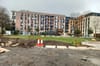 An image of Diamond Park, with two cones and evidence of construction work. Dug up ground and slabs of concrete in the foregr