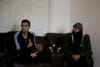 Mohamad Sadat Snunu and his father Mahmud sit on the couch at home. Photo by Shamim Malekmian.