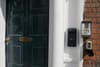 A key-box outside a black door.