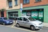 A silver car parked on the side of the road.