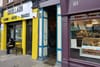 A narrow entrance that looks a bit like an open doorway sits between two shops on Thomas Street. This is the entrance to the