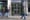 The big glass doors at the entrance to the offices of the Residential Tenancies Board. One man walks by, and two stand talkin
